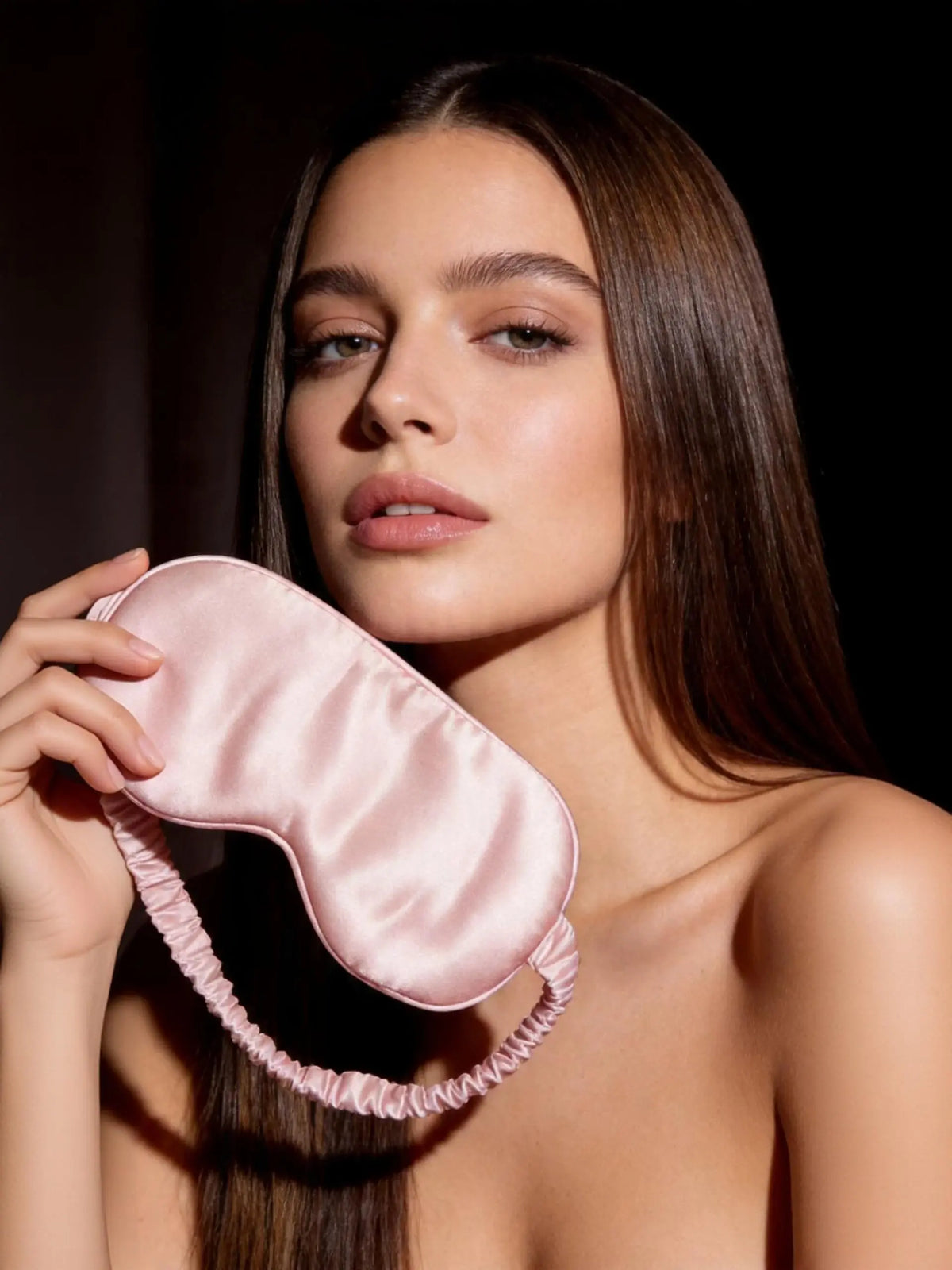 beautiful woman holding 22 momme mulberry silk sleep mask in pink